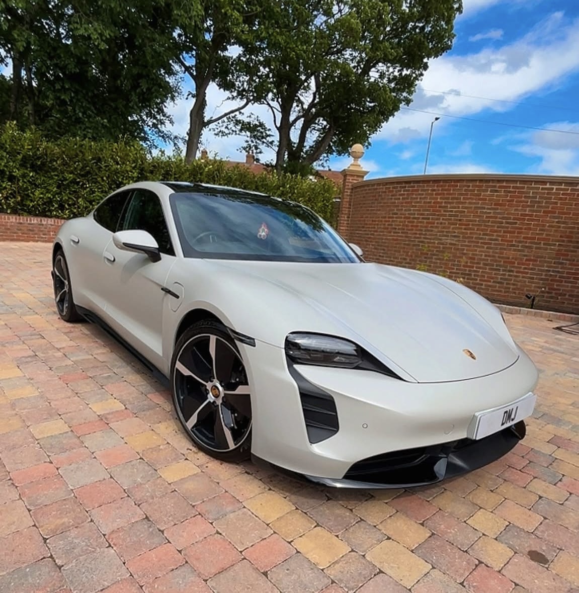 White Porsche photographed outdoors after detailing