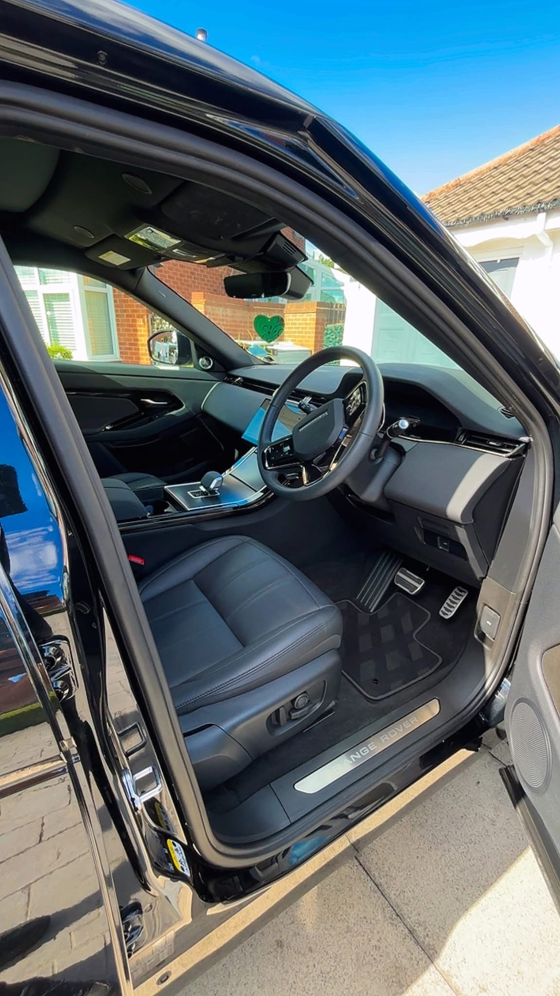 Clean, well-presented vehicle interior viewed through the open driver's door